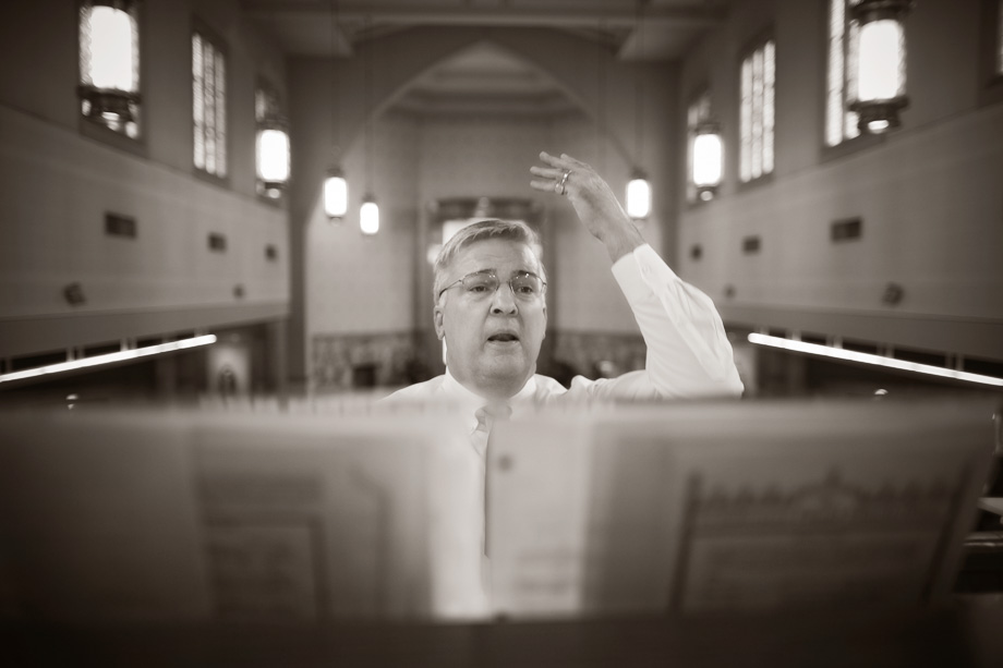 At the back of the church a man is leading the music.