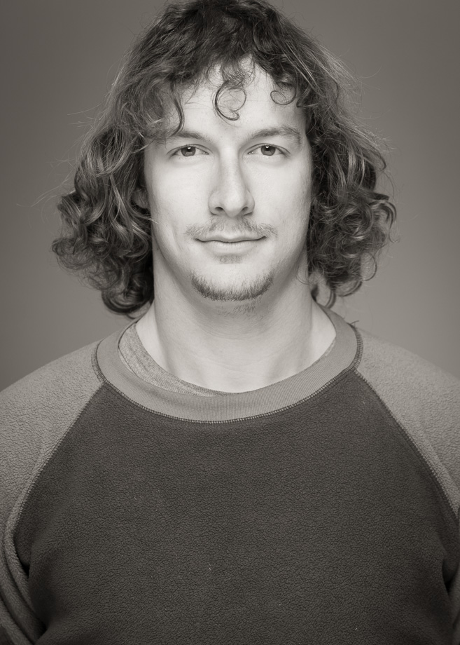 headshot of young man with long hair